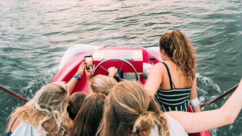 Free Group of People Riding Red Boat Stock Photo
