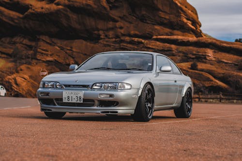 Gray Nissan Silvia with Rocks behind