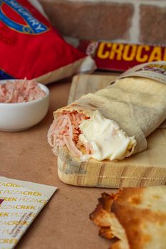 Close-up of a tasty wrap sandwich with ham and cheese, perfect for a quick meal.