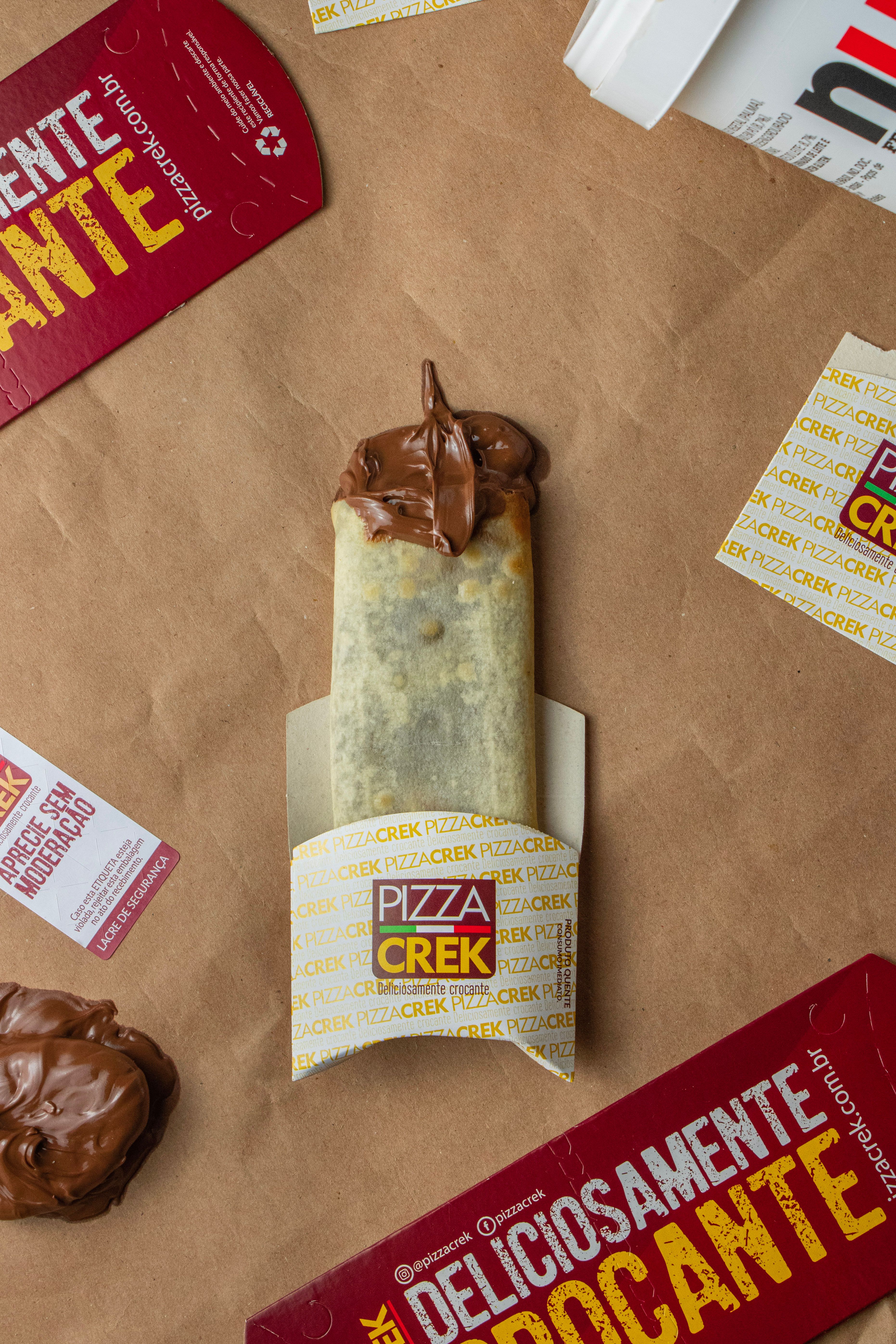 Delicious Pizza Crek wrap topped with rich chocolate spread on kraft paper.