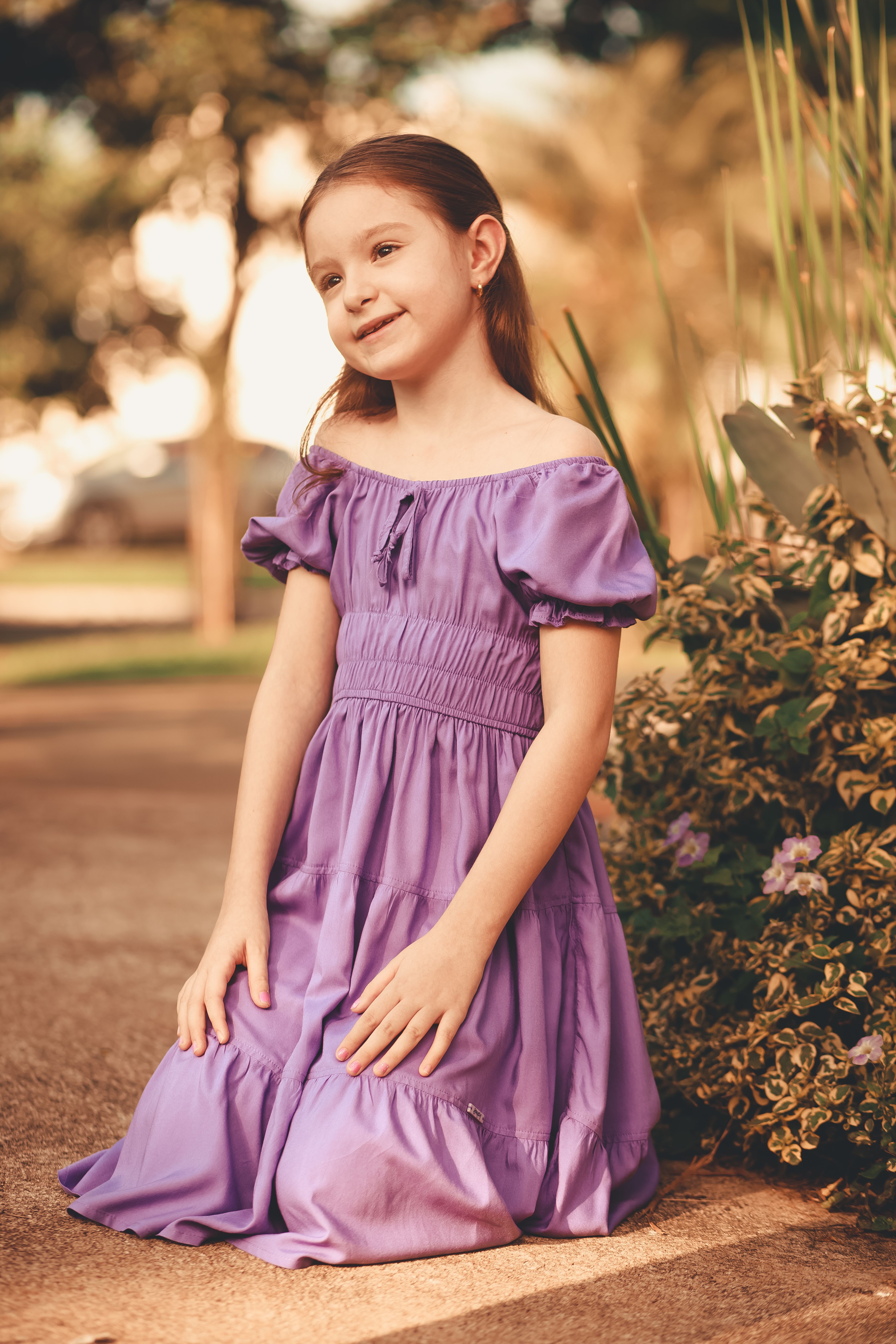 Girl in Dress Kneeling and Smiling · Free Stock Photo
