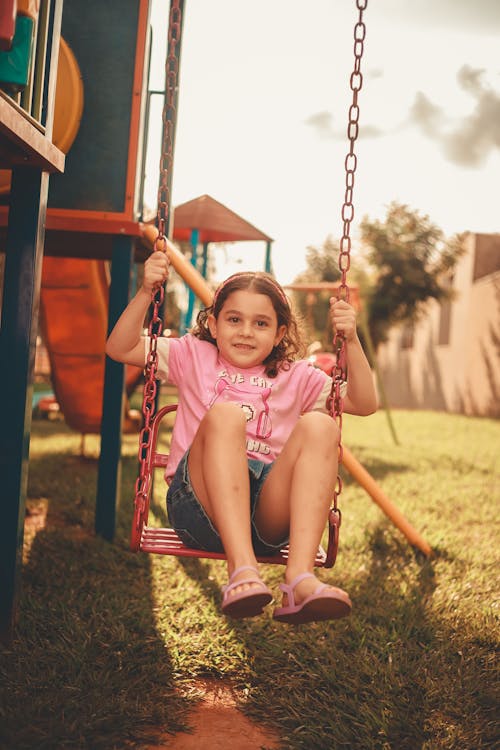 Girl Sitting and Posing on Swing