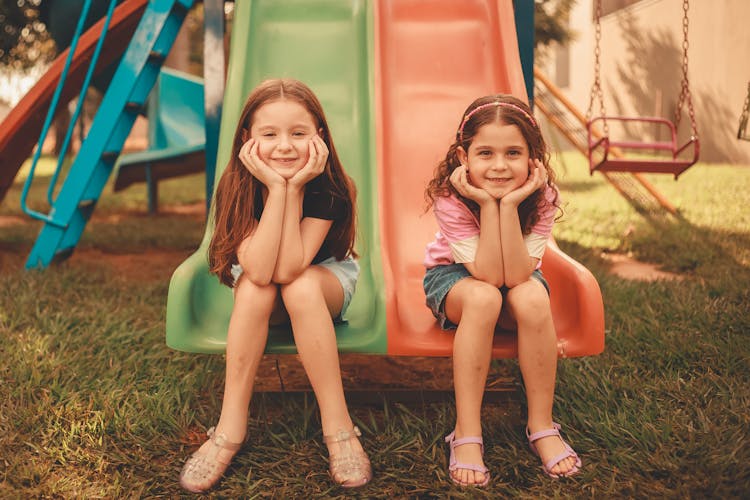 Girls Sitting On Slides