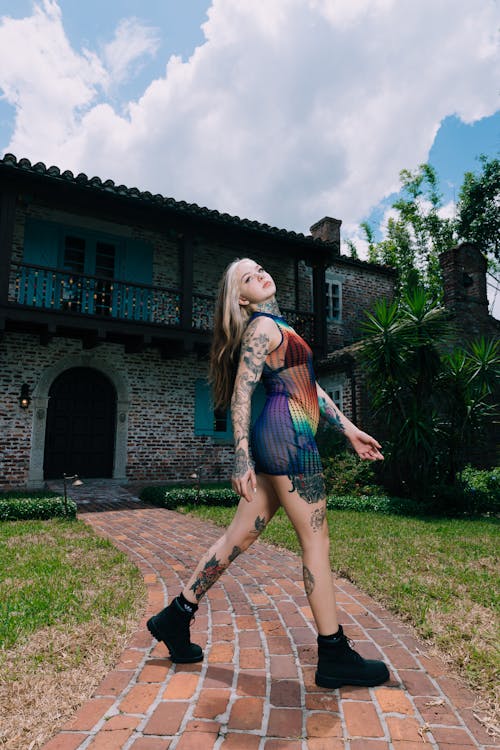 Model with Tattoos Posing in Bodysuit · Free Stock Photo