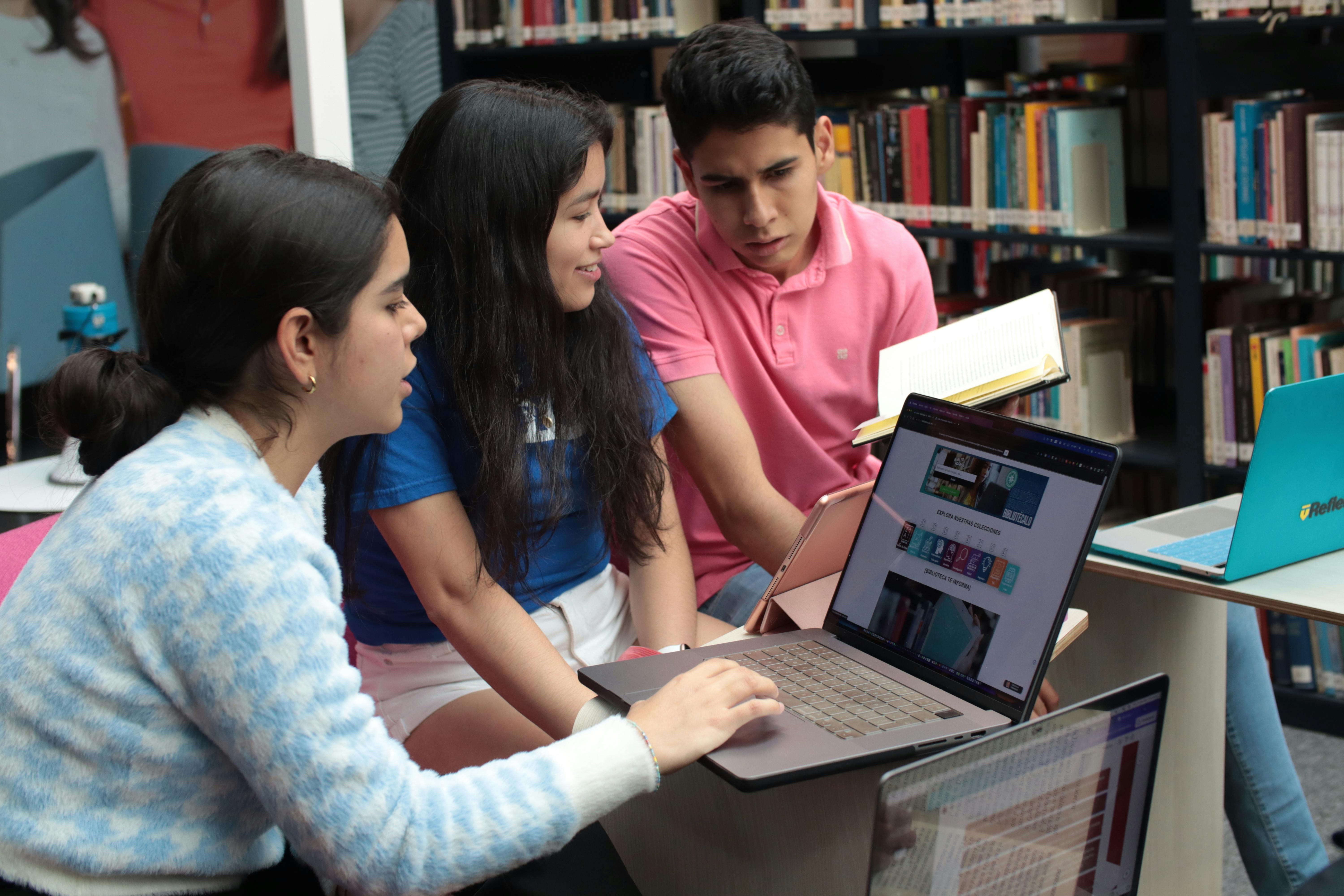 a group of students sitting in a library and studying