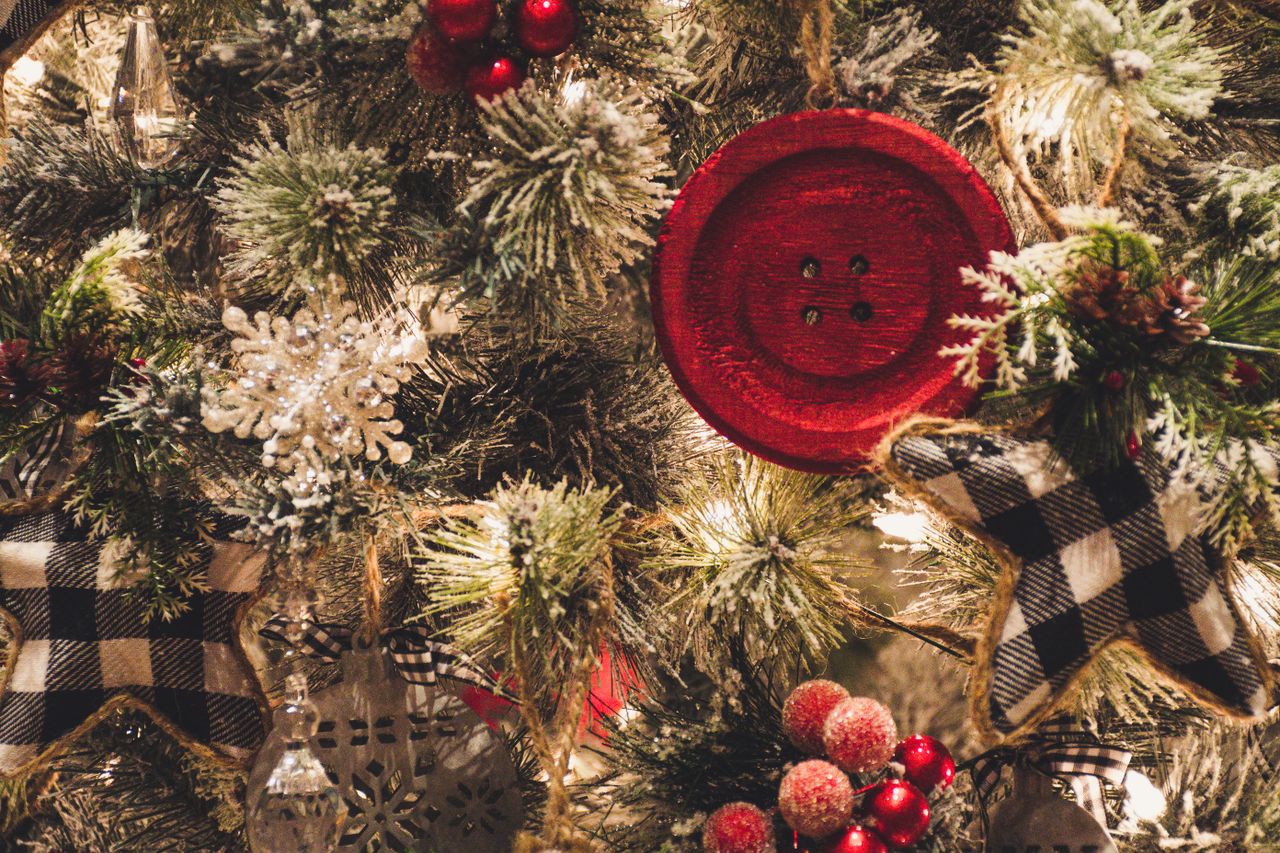 close up of a christmas tree decorated with a red button snowflakes be