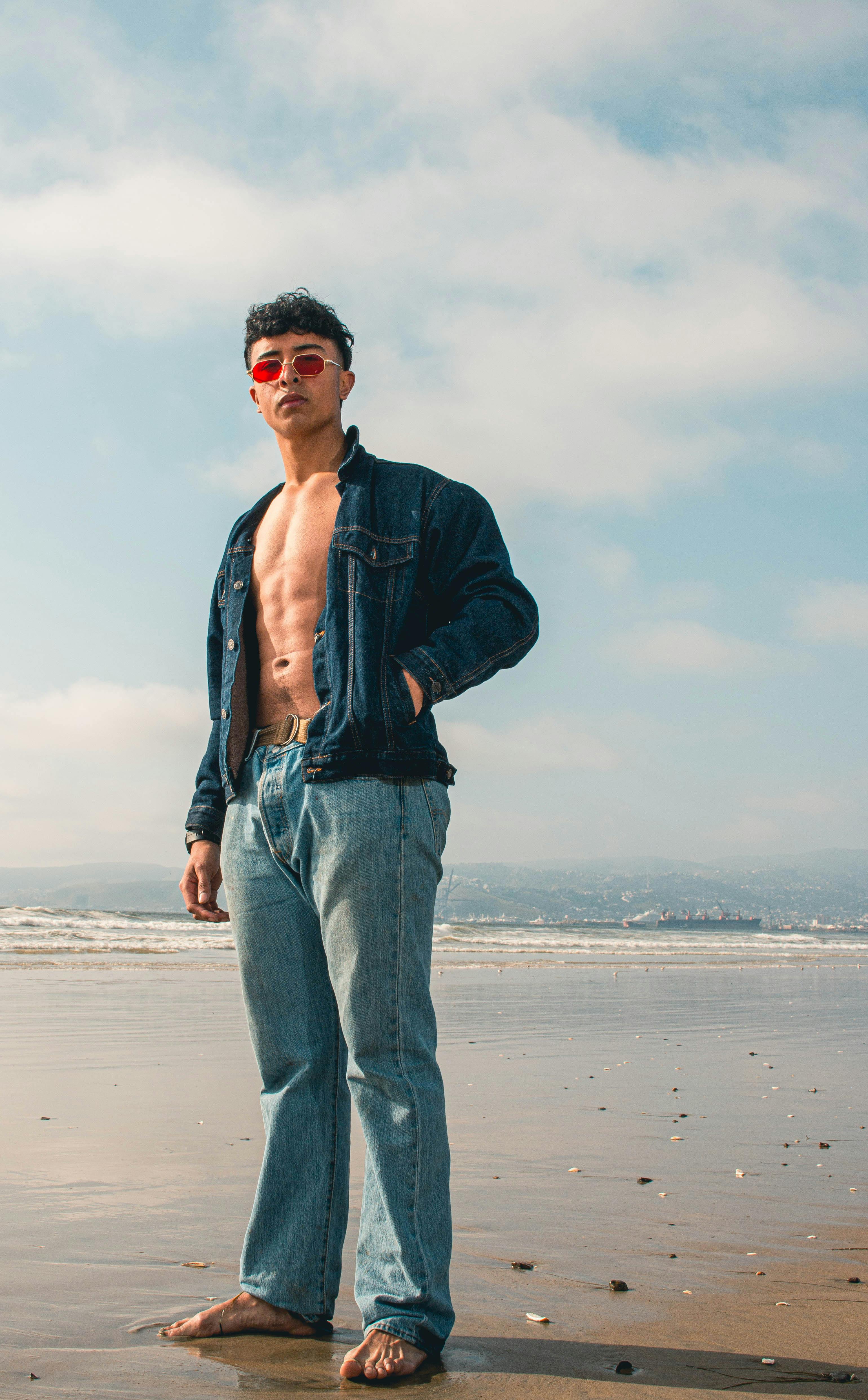 Young Man in Jeans Standing in Sea · Free Stock Photo