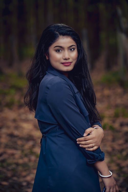 Young Brunette in a Black Coat Posing Outdoors 