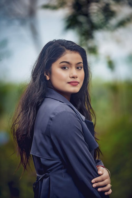 Young Brunette in a Black Coat Posing Outdoors 