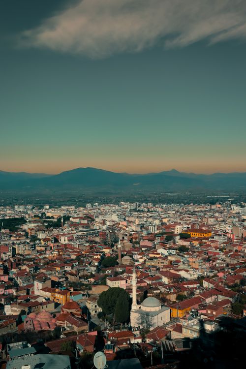 Free Discover the stunning aerial cityscape of İzmir, Türkiye showcasing the vibrant blend of architecture at sunset. Stock Photo