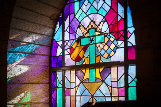 Old authentic medieval church on a noble real estate with authentic original details and beautiful colored windows with religious images