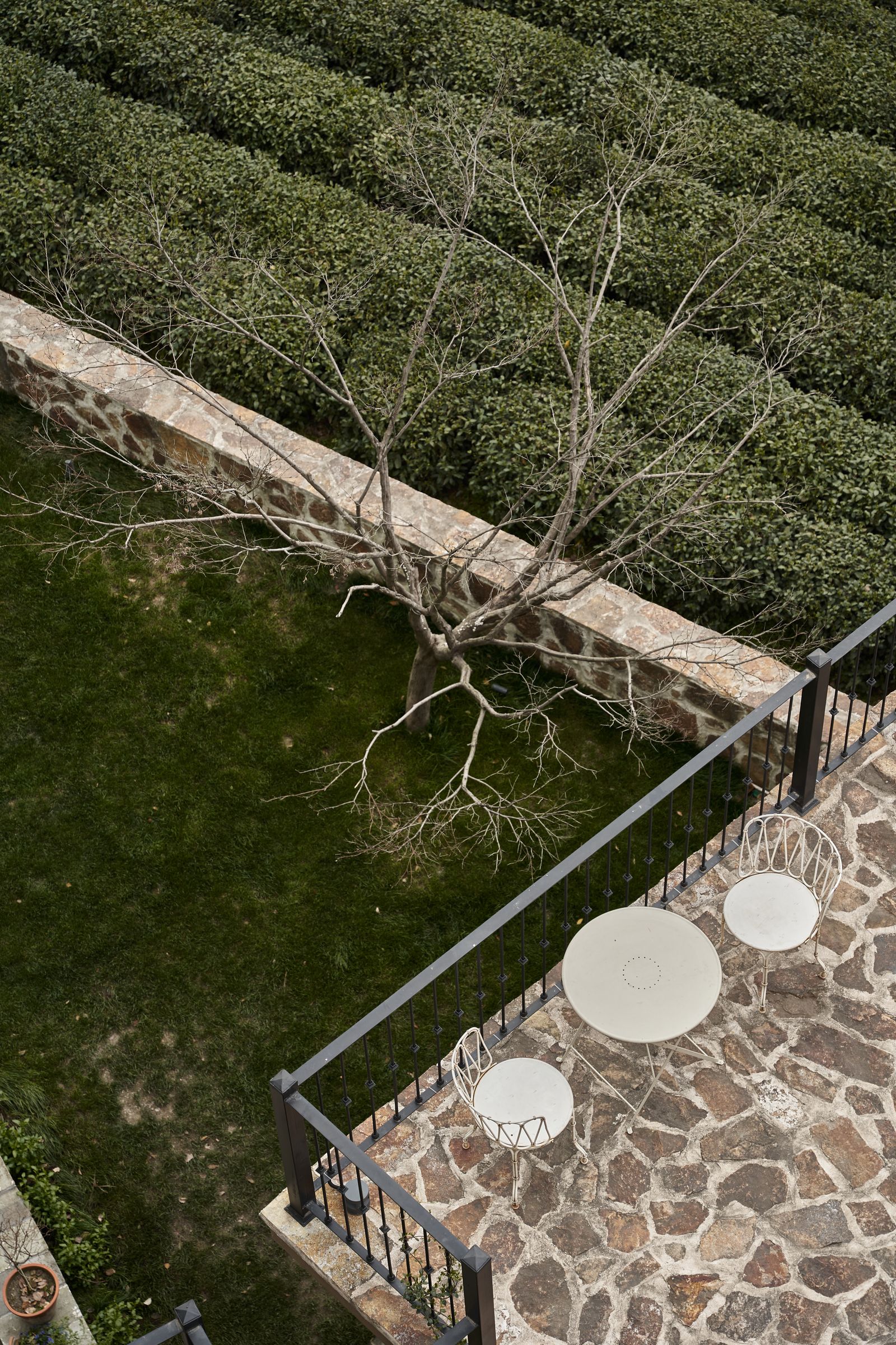 Terrace with natural stone flooring beside a garden