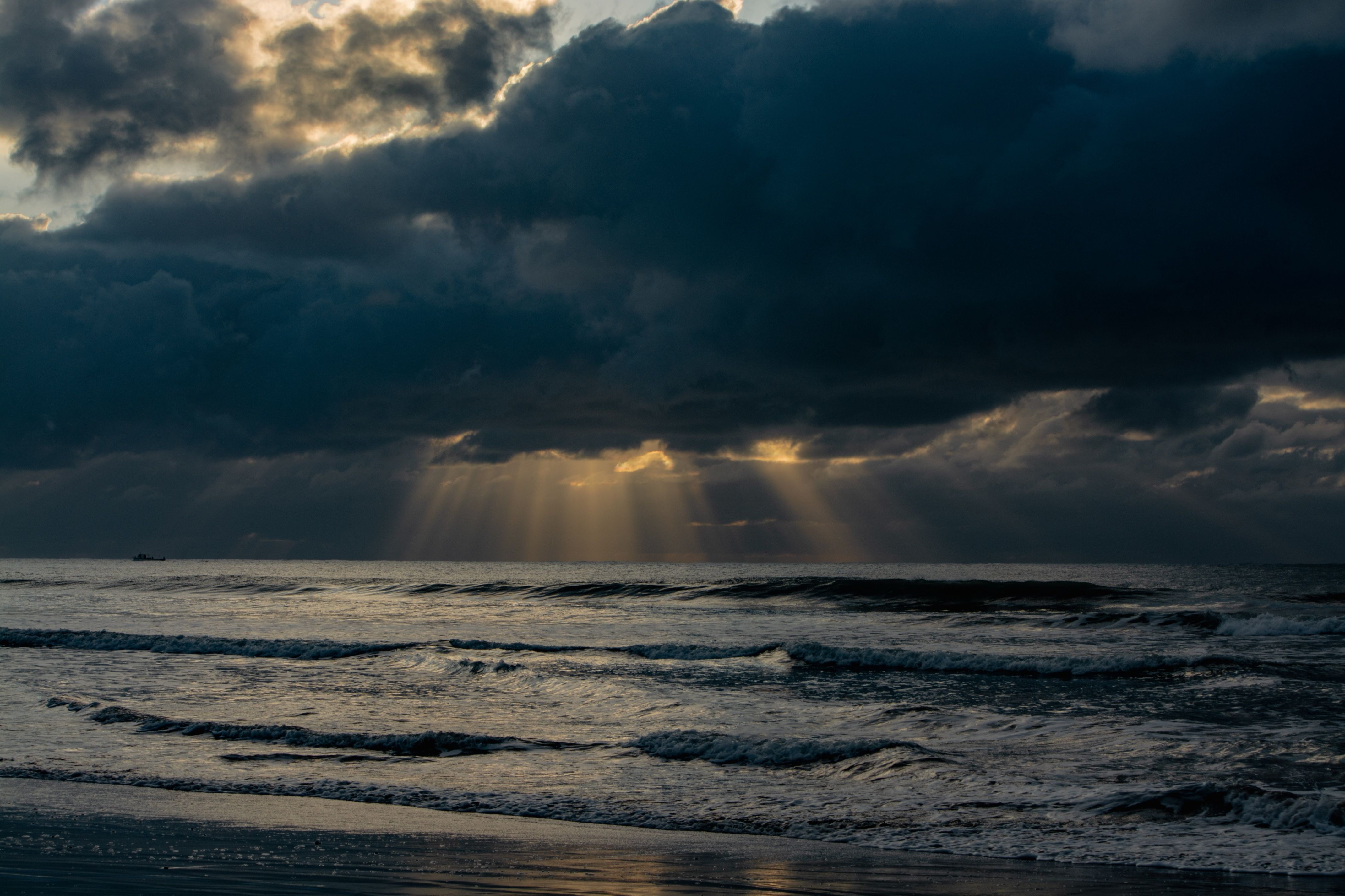 Sunbeams behind Storm Clouds over Sea · Free Stock Photo