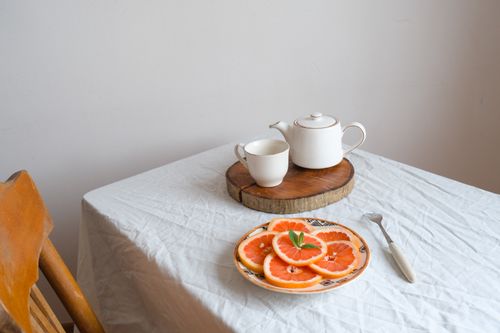 Free Top view of a tea set and grapefruit slices on a table, evoking a fresh and cozy atmosphere. Stock Photo