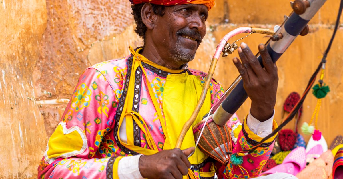 A man in traditional clothing playing a musical instrument · Free Stock ...
