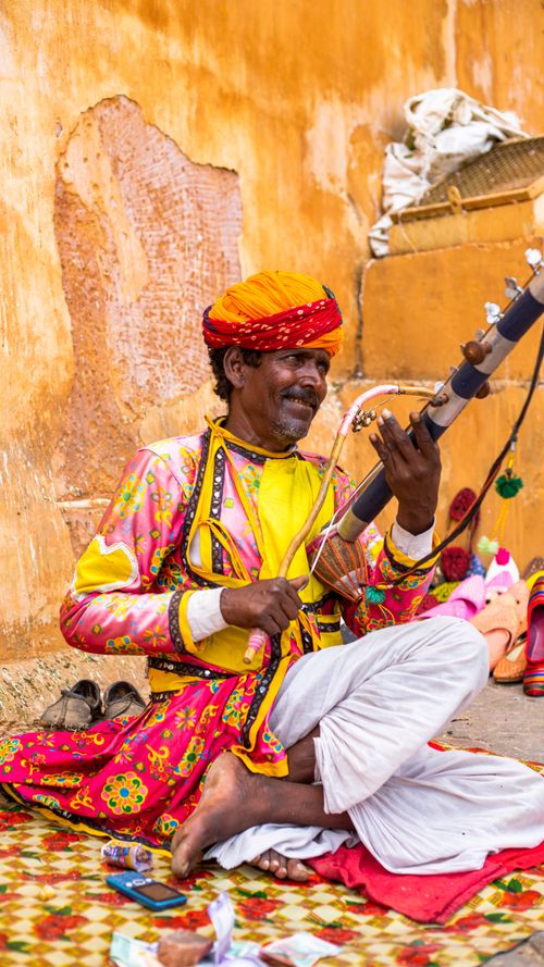 Free Vibrant image of a Rajasthani musician playing the kamayacha in colorful attire. Stock Photo