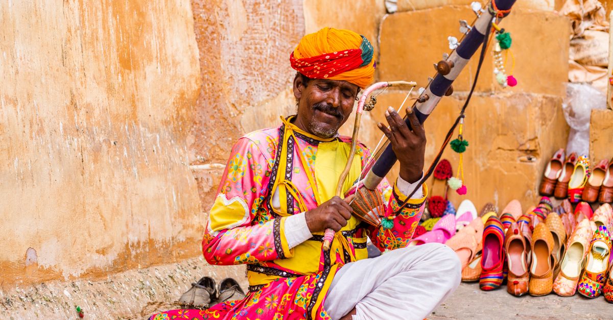 A man in traditional clothing playing a musical instrument · Free Stock ...