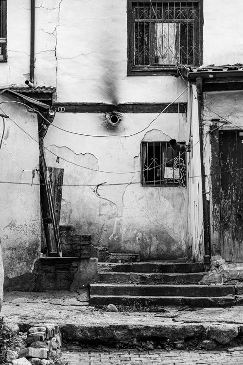 Free Black and white photo of a decaying building facade with steps in Ankara. Stock Photo