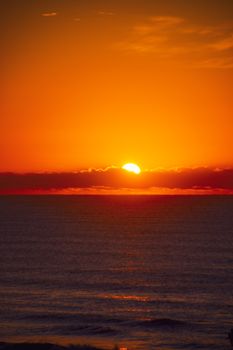 Beautiful orange sunset over a tranquil sea, capturing the serene and warm ambiance.