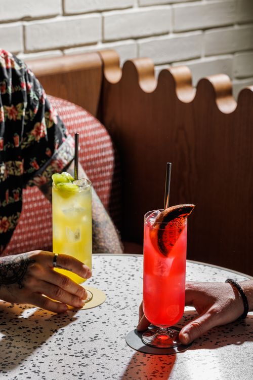 Free Vibrant cocktails in stylish glasses on a sunny café table in Maleshiya, UP, India. Stock Photo