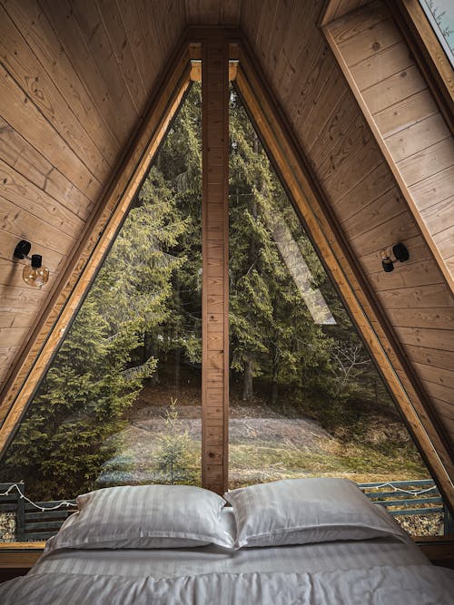 Bed in Wooden Hut with Windows