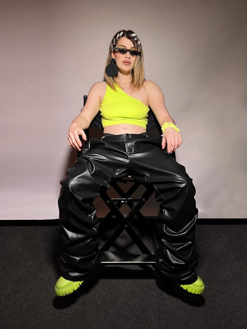 Woman Sitting and Posing in Leather Trousers