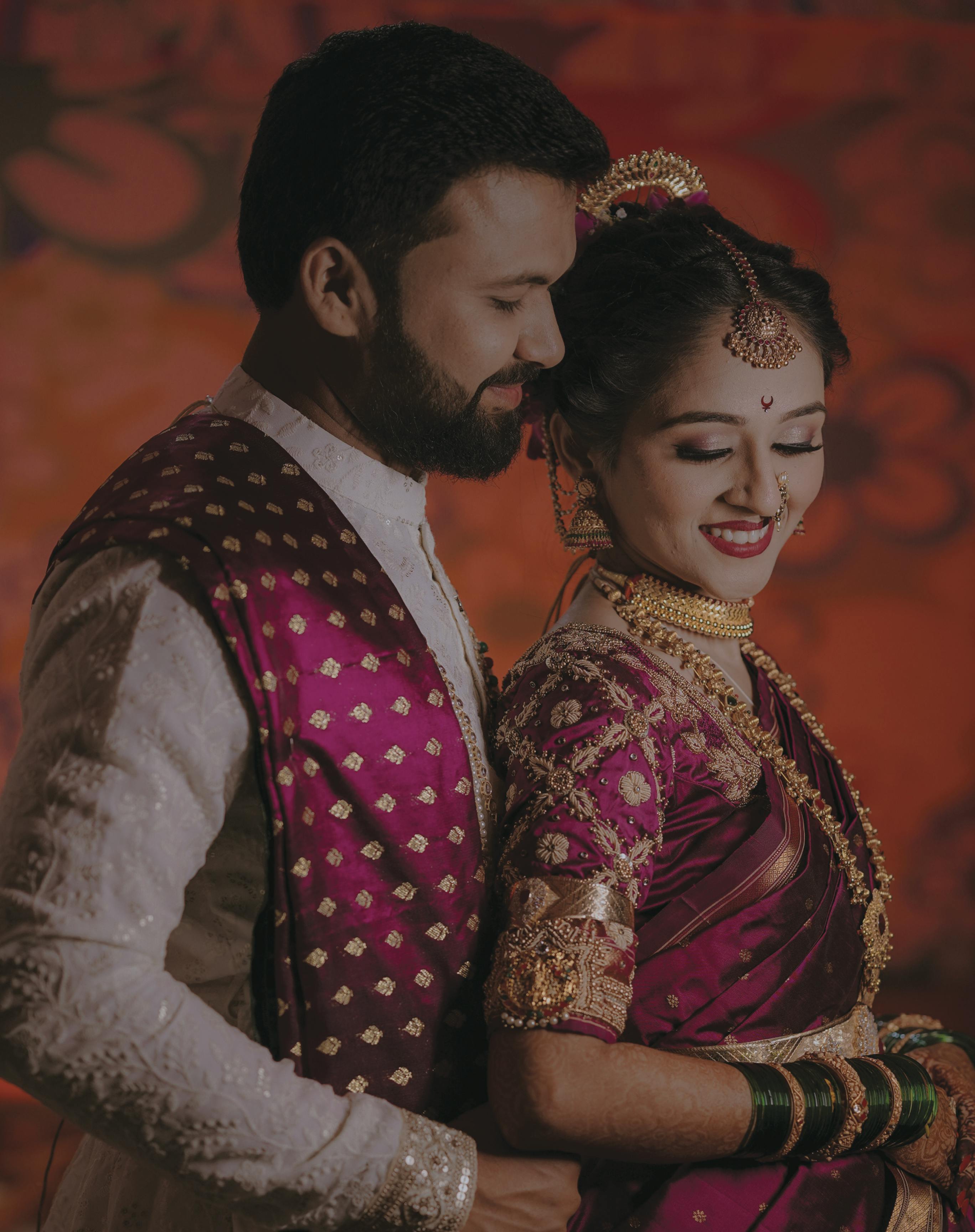 Beautiful Indian couple in traditional wedding attire, capturing a joyful moment.
