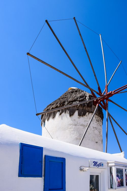 Free Iconic white windmill against a clear blue sky in Mykonos, Greece. Stock Photo
