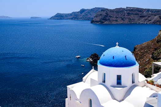 Experience the breathtaking beauty of Santorini's iconic blue-domed churches overlooking the Aegean Sea.