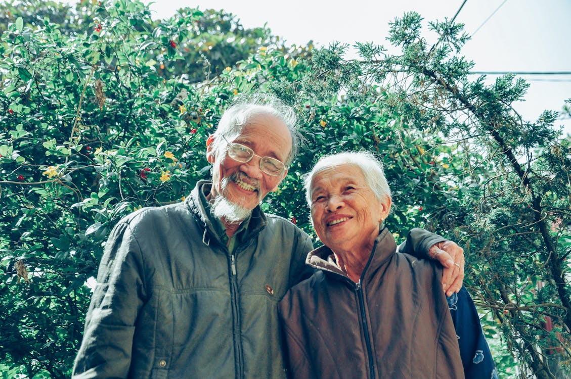 Smiling Man and Woman Wearing Jackets