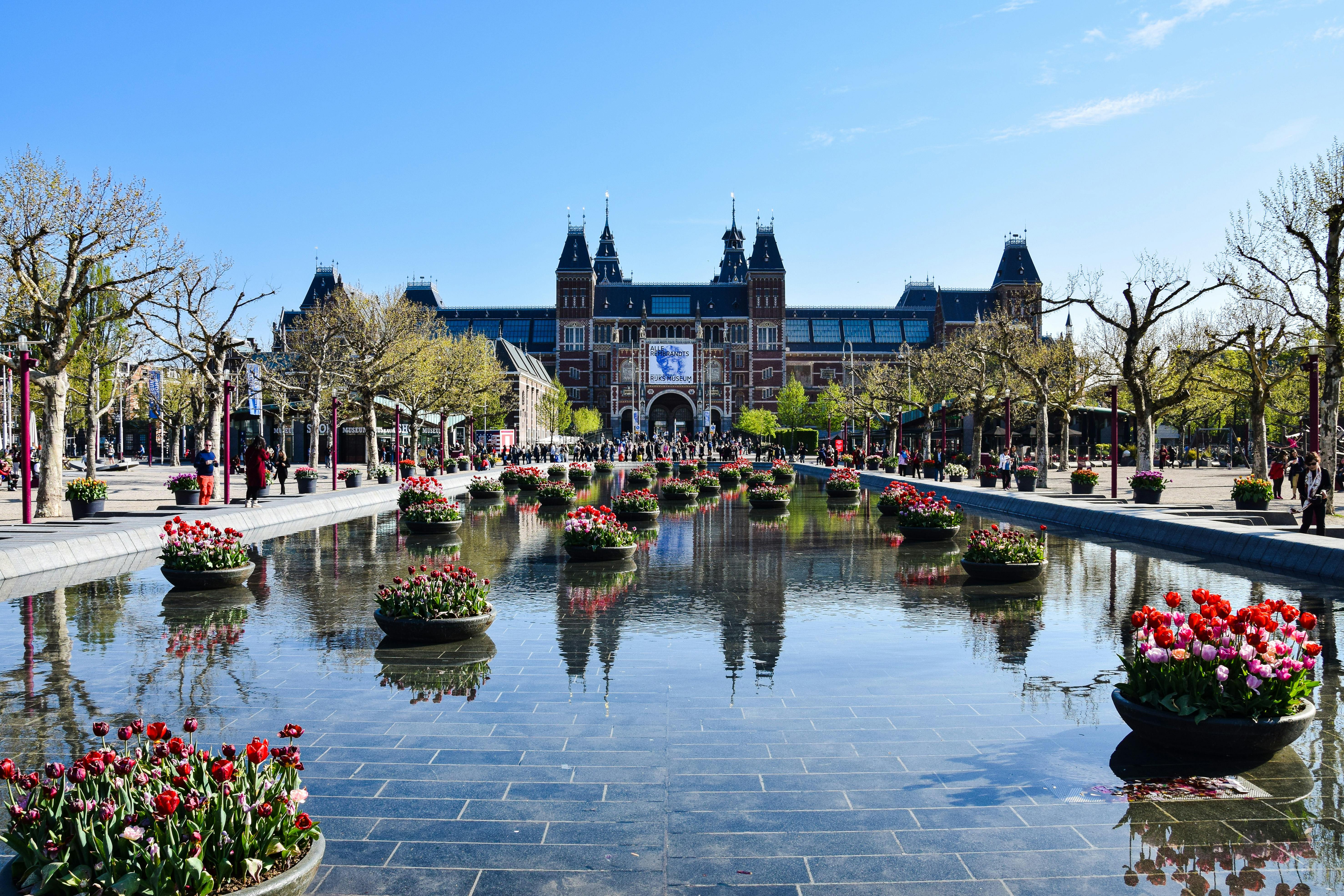 Rijksmuseum with gardens and reflecting pool in Amsterdam.
