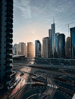 Captivating view of Dubai's modern skyline with skyscrapers at sunrise, showcasing urban architecture.