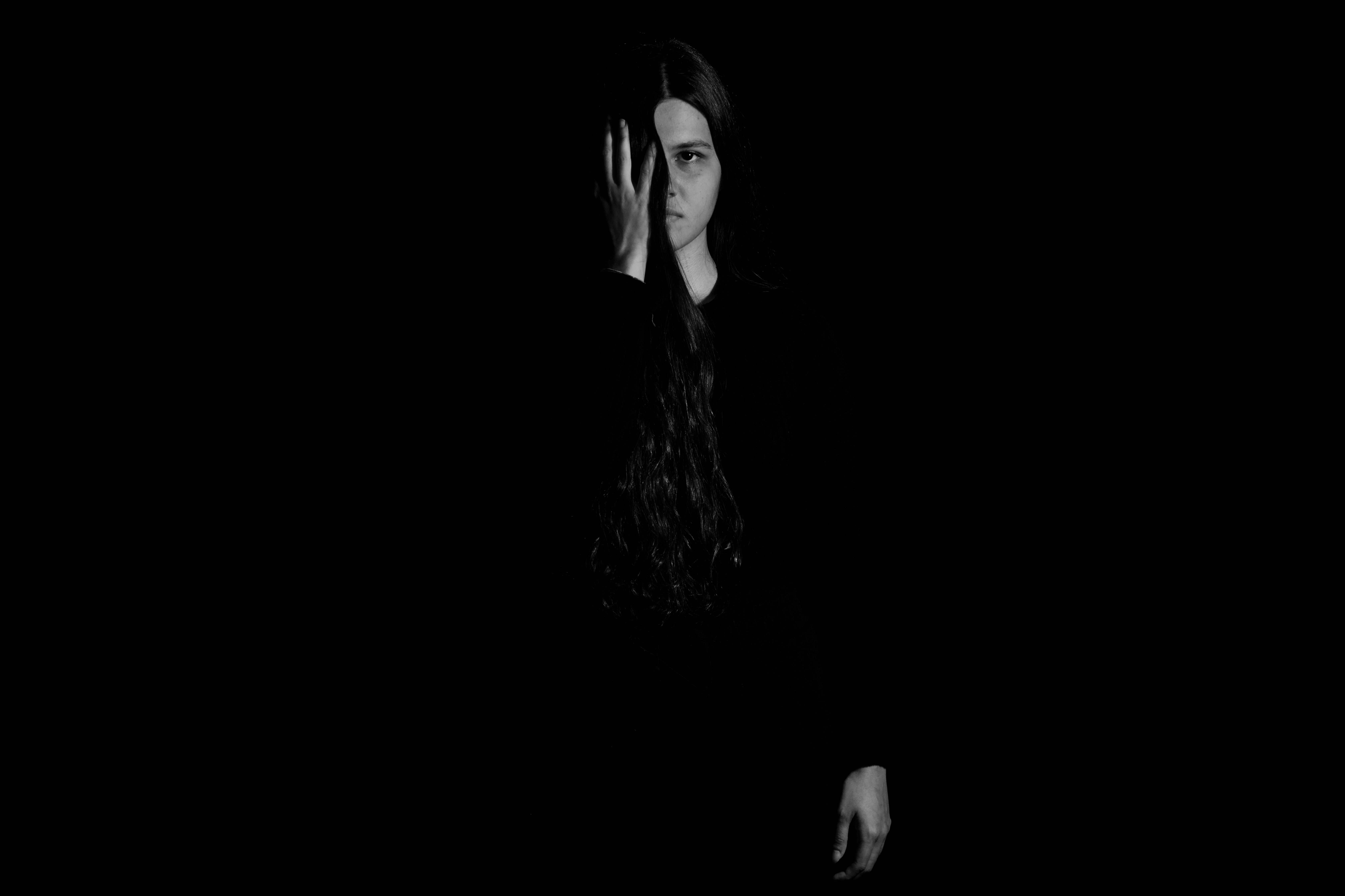Woman in Black Clothes Posing in Darkness · Free Stock Photo