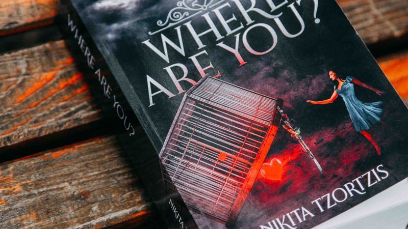 Book cover of 'Where Are You?' by Nikita Tzortzis placed on a wooden bench.