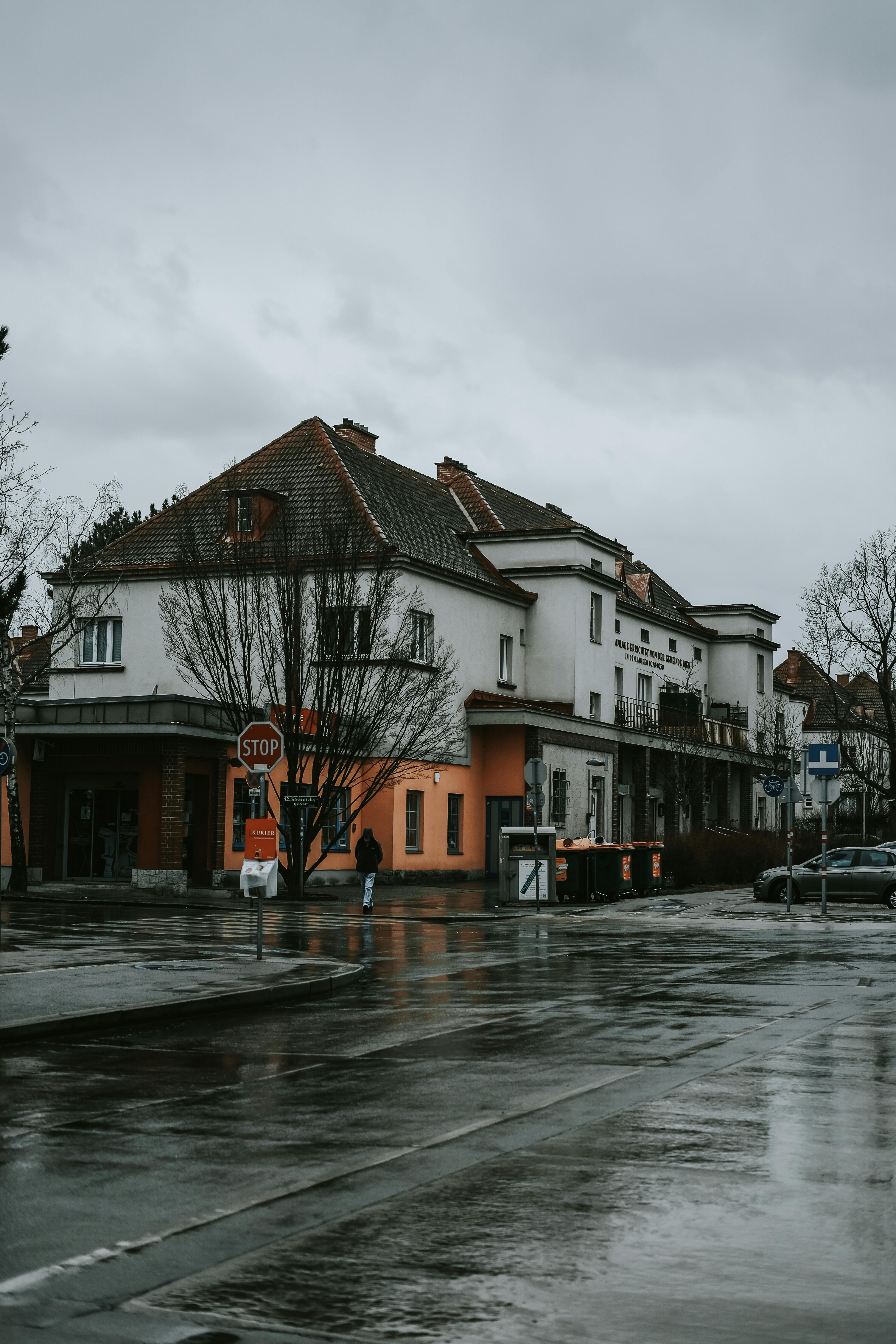 a rainy day in the city with buildings and cars