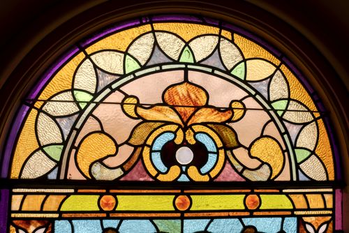 Free Colorful stained glass window featuring intricate patterns in Winona, MN church. Stock Photo