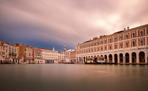 Smooth Surface of the Canal Grande and Traditional Buildings Facades, Venice, Italy 