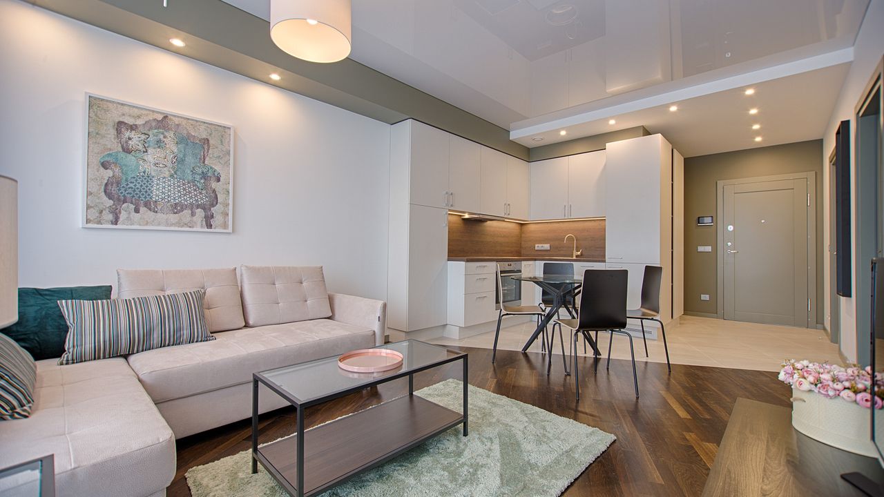 Compact living room furniture arrangement Compact apartment living room using appropriately sized furniture to keep the space open