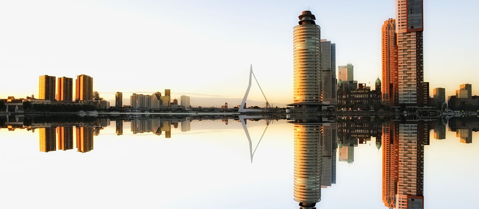 Captivating view of Rotterdam skyline reflecting in water at dusk, showcasing modern architecture. — flights from Istanbul to Rotterdam