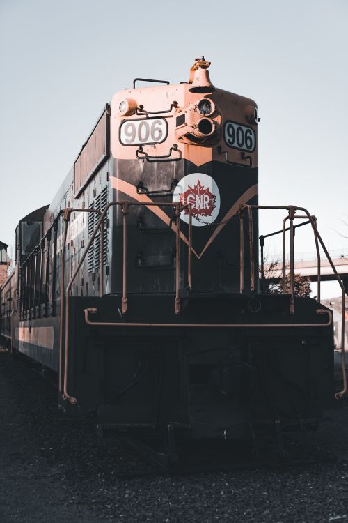 Free Old-fashioned locomotive on railway track in a nostalgic setting. Stock Photo