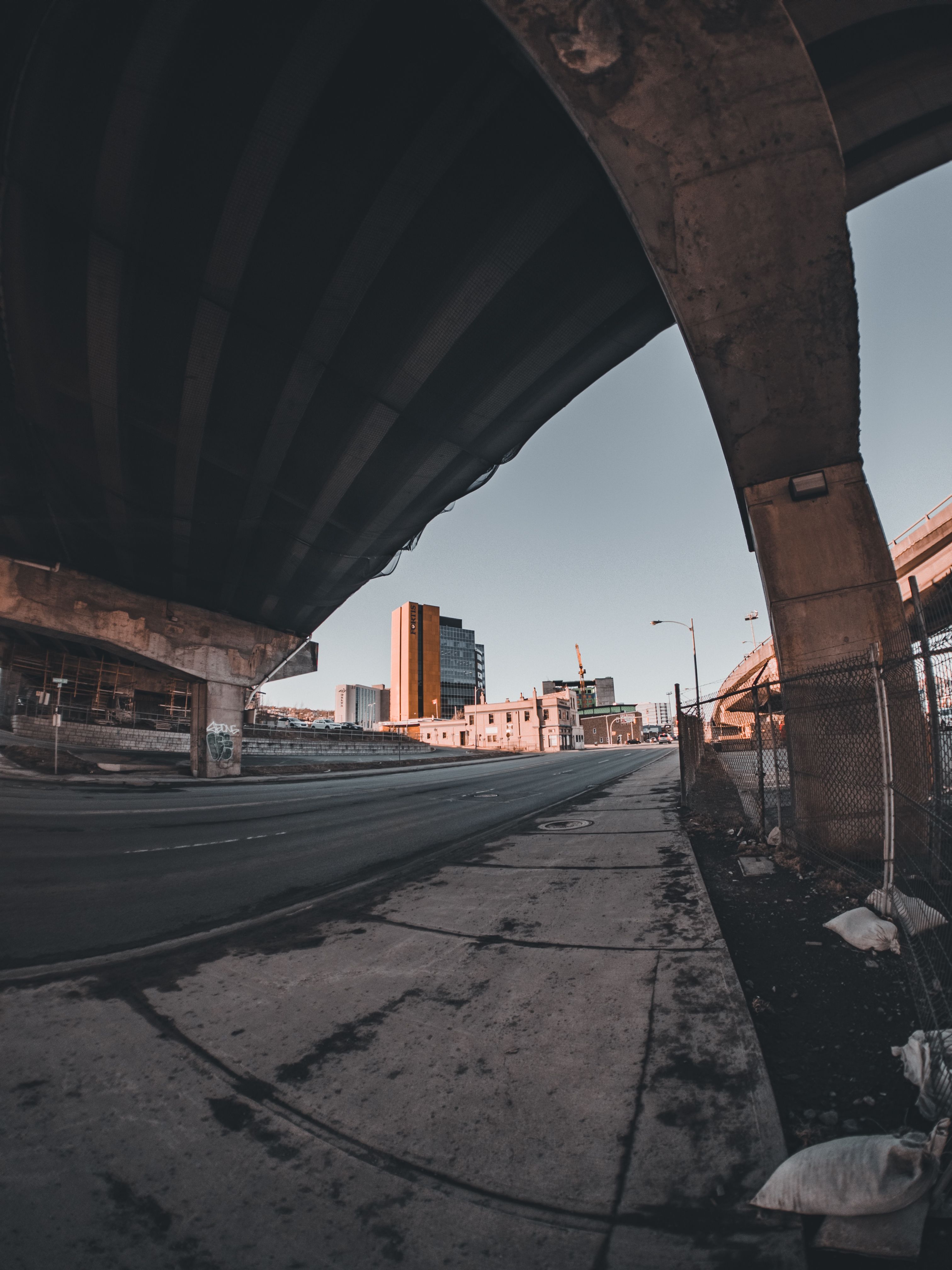 A dramatic view of the urban landscape under a bridge in St. John's, Canada.