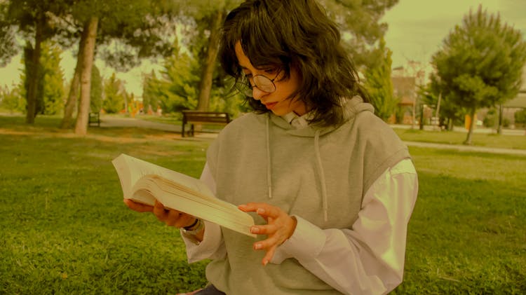 Woman Reading Book At Park