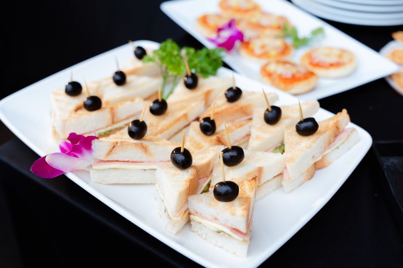 Mini sandwiches and savoury bakery bites arranged for catering