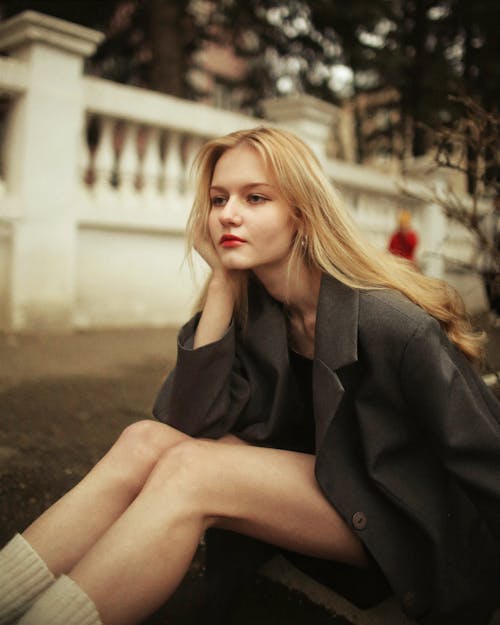 Blonde Woman Sitting on the Ground