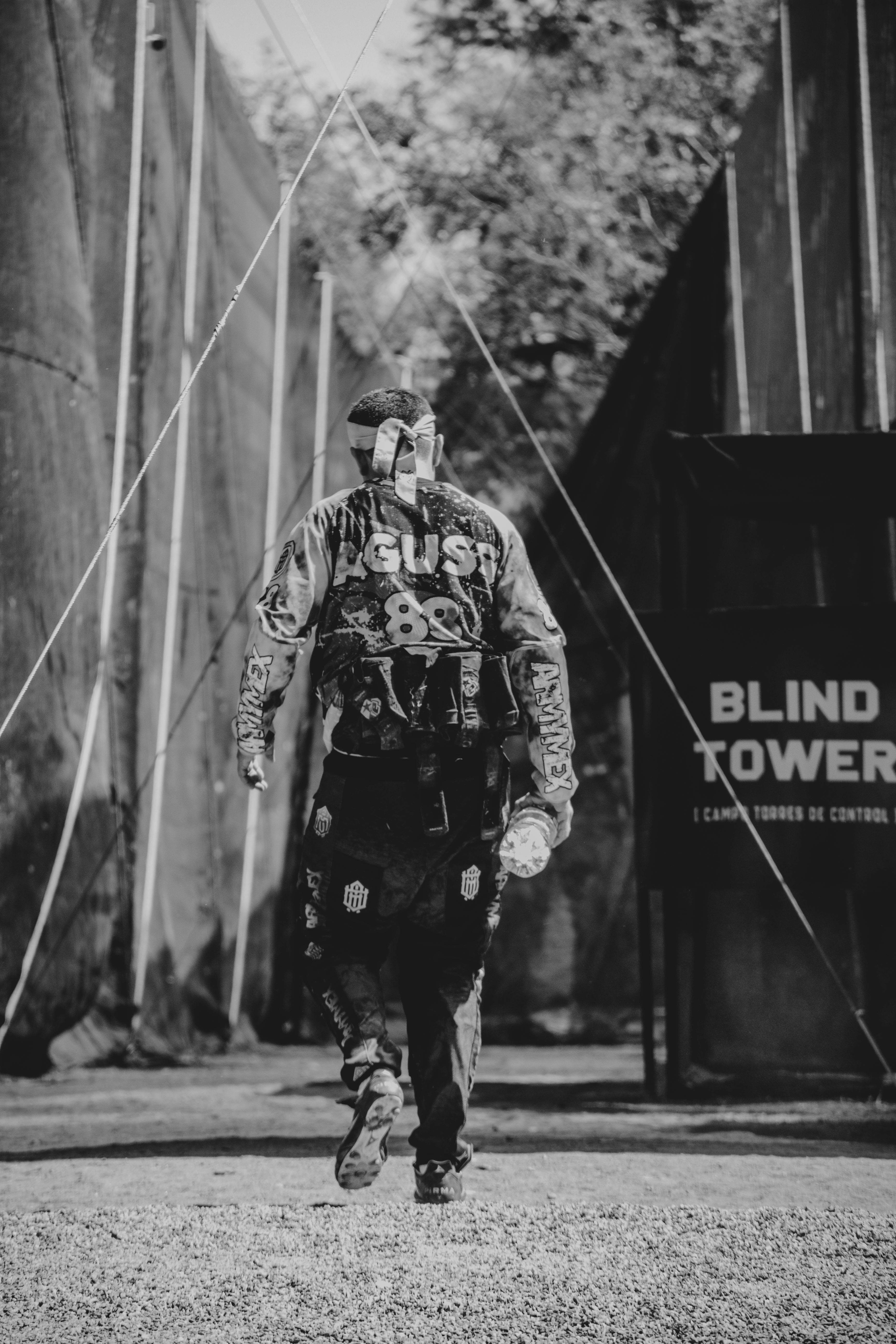 Monochrome image of a paintball player walking towards the tower in a game arena. Prescription Goggle Inserts - Monochrome image of a paintball player walking towards the tower in a game arena.