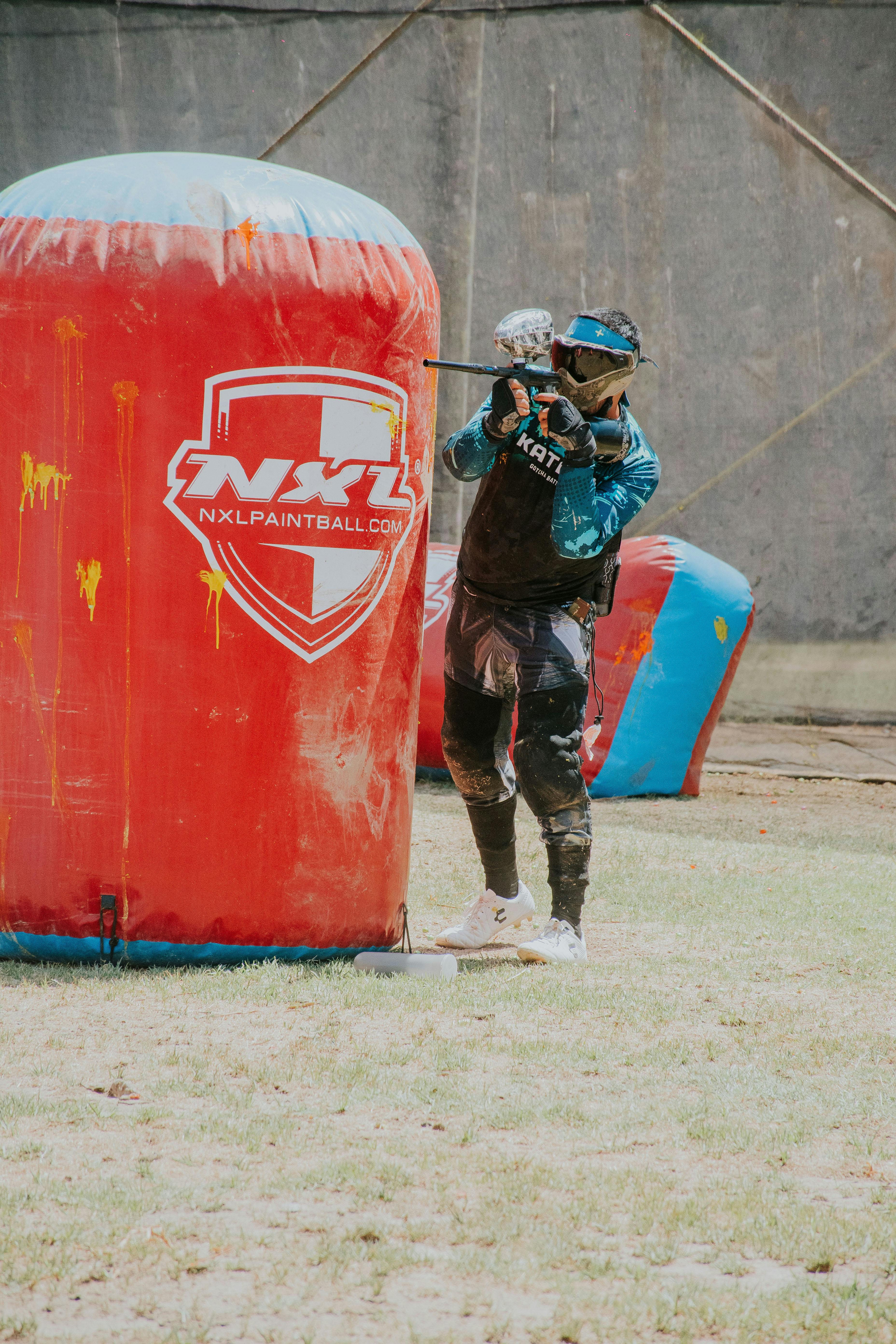 A paintball player aims during an outdoor match, seeking victory in paintball sport. Prescription Goggle Inserts - A paintball player aims during an outdoor match, seeking victory in paintball sport.