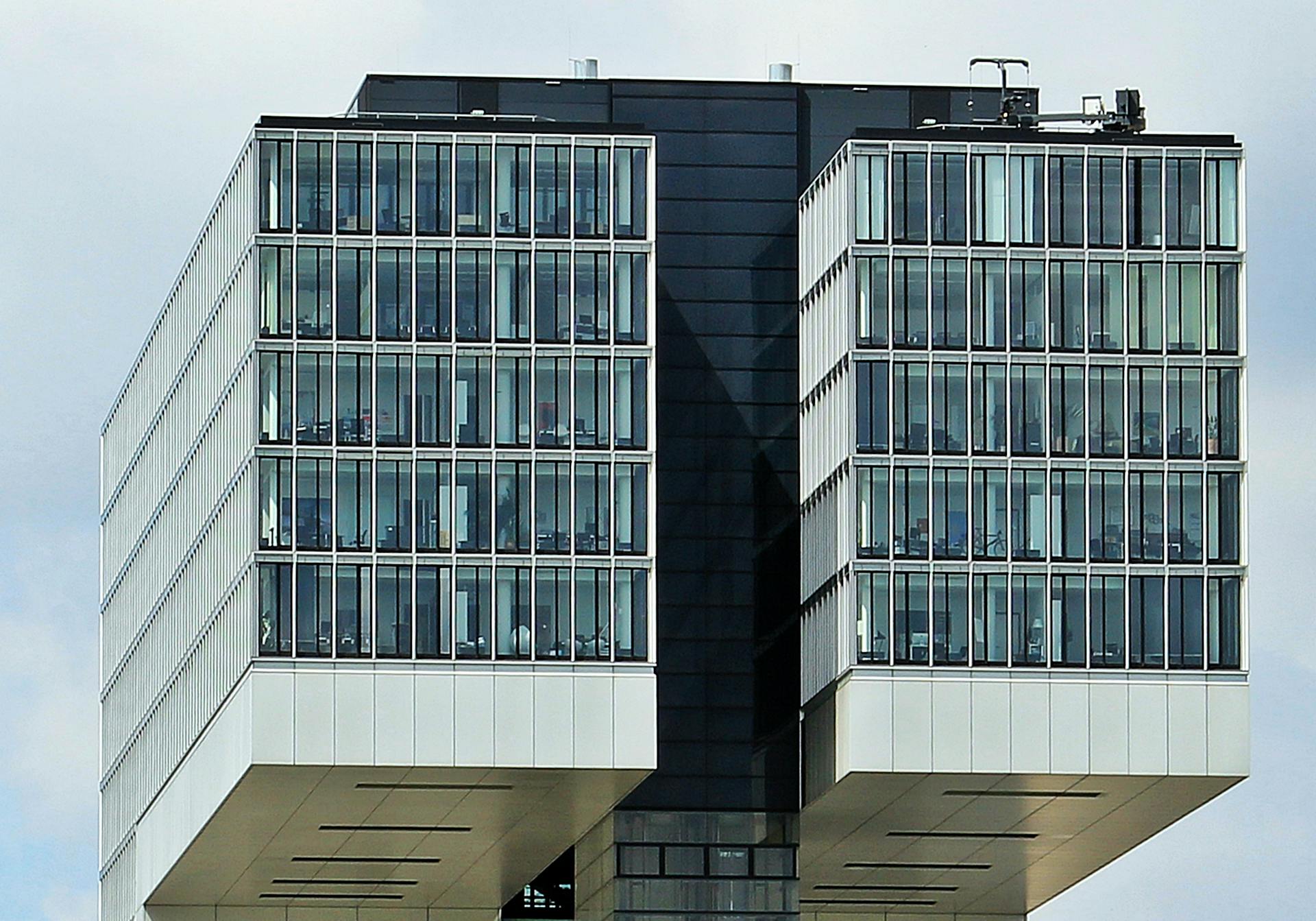 Close-up of a sleek and futuristic office building with glass windows.