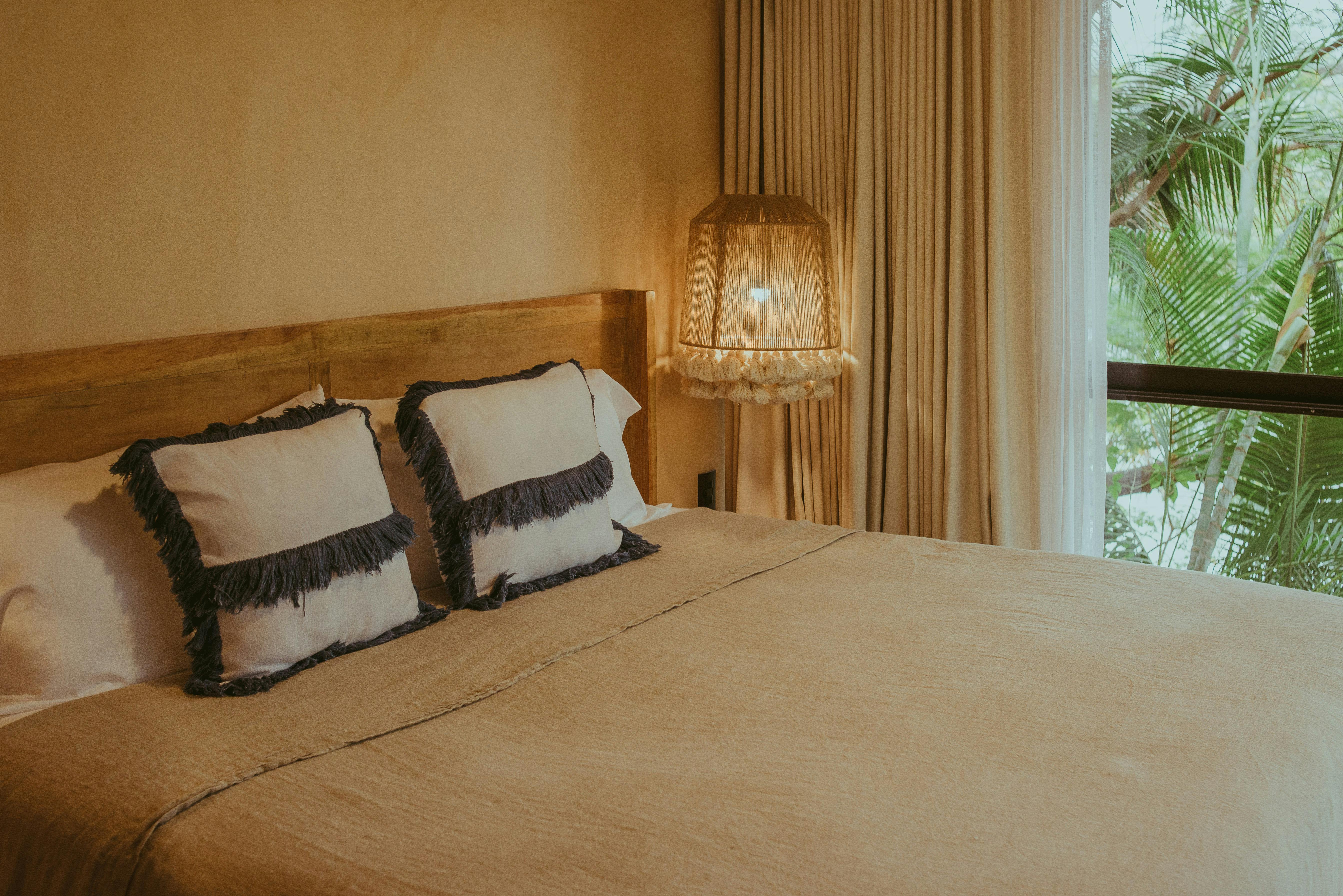 Dressing Gowns Folded on a Bed with White Sheets in a Hotel Room · Free Stock Photo