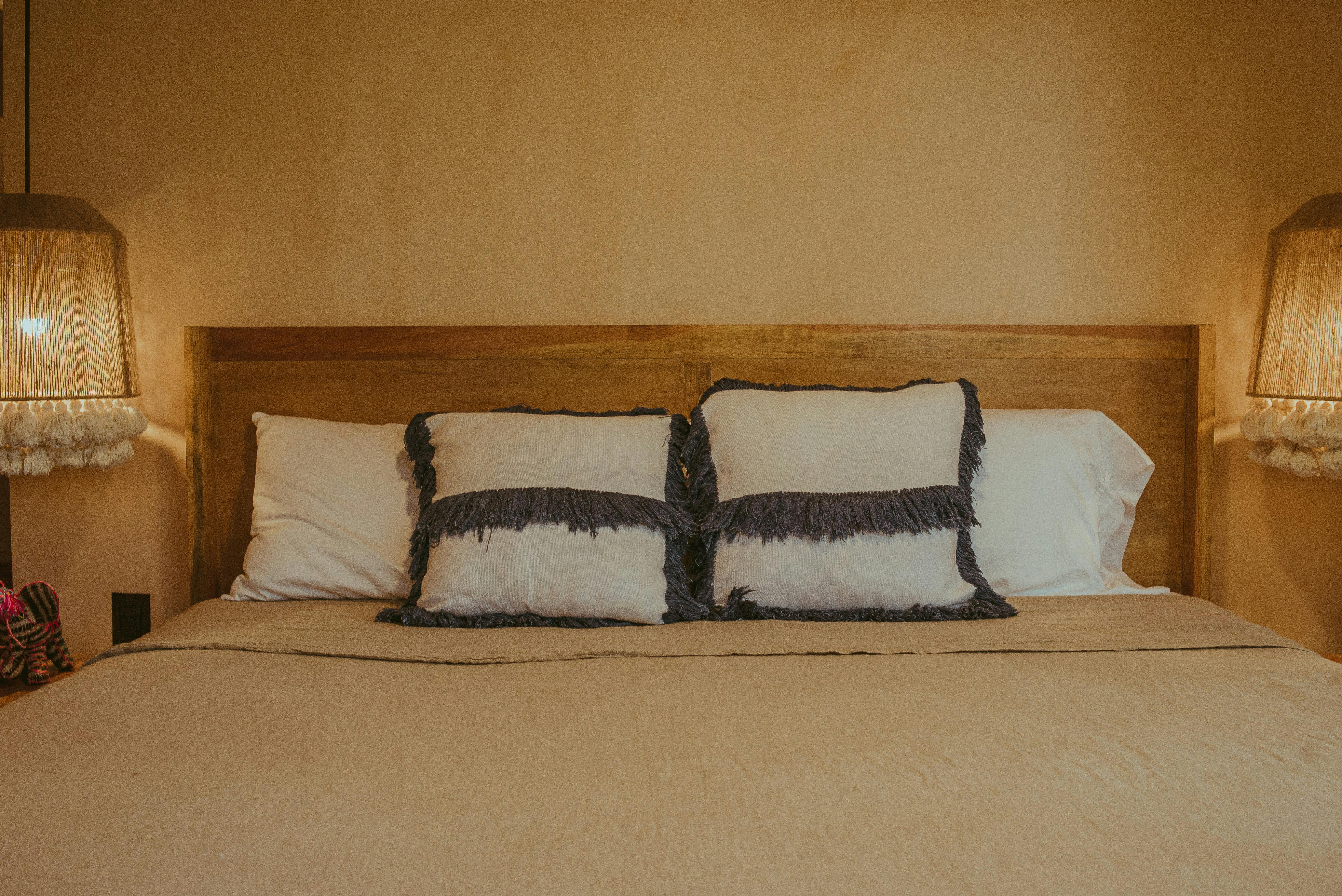 Dressing Gowns Folded on a Bed with White Sheets in a Hotel Room · Free Stock Photo
