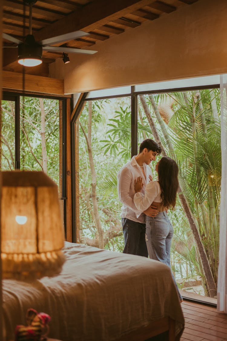 Couple Embracing In Bedroom